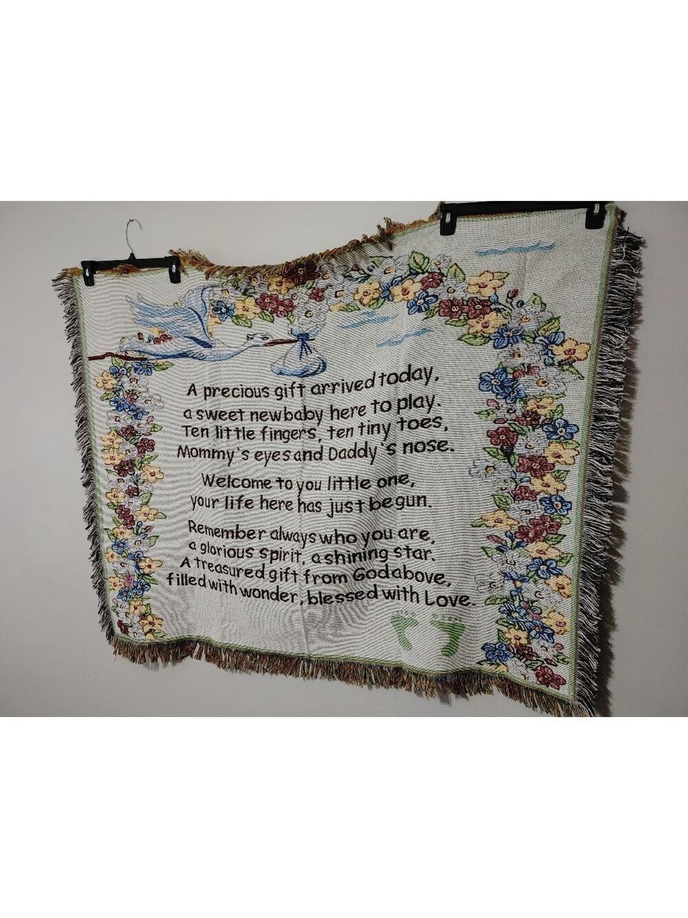 "Baby arrived" tapestry throw blanket featuring a floral border, a stork, poem